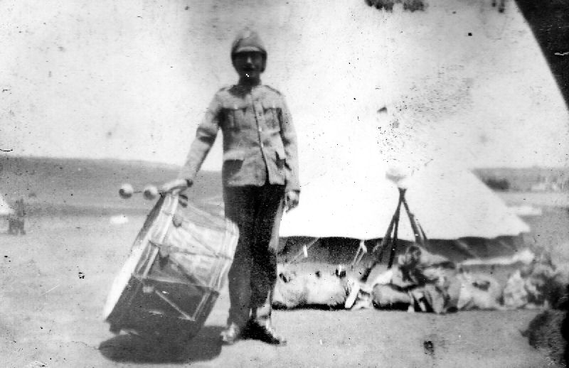 Drummer outside his tent